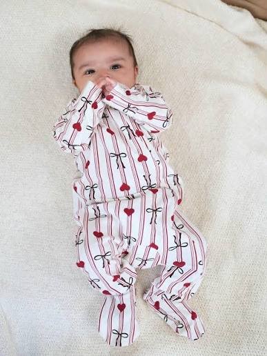 Sleeping baby in soft cotton sleepsuit